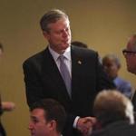 Governor-elect Charlie Baker entered a ballroom at the Seaport Hotel on Wednesday to address the media and supporters.