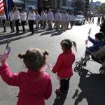 Two little girls watched as Boston's Veterans Day parade made its way around Boston Common last year. 
