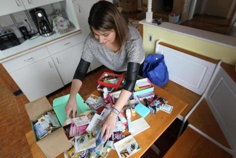 Tanya Andre, who sends herself three boxes each month, displays a year?s worth of leftover products on the kitchen table of her Ludlow home.
