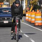 A cyclist pedaled along Beacon Street in Somerville, where construction has begin on a bicycle lane.