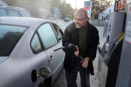 James O'Connell of Worcester filled his car at a Cumberland Farms near home before his daily commute to bring son Owen (in car) to school in Connecticut.
