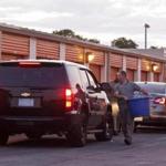 Officials loaded evidence into vehicles at a Weymouth storage facility in July.