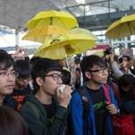Hong Kong Federation of Students envoys (from left) Alex Chow, Nathan Law, and Eason Chung talked to the news media Saturday before attempting to board a plane to Beijing.  