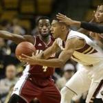 Massachusetts guard Jabarie Hinds, left, and guard Derrick Gordon, right, try to block Boston College guard Olivier Hanlan, center, in the first half of an NCAA college basketball game, Sunday, Nov. 16, 2014, in Boston. (AP Photo/Steven Senne)