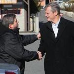 Local state senator, the minority leader Bruce Tarr, greets governor-elect Charlie Baker as he arrives to meet with fishermen to hear their concerns about the recent ban on cod fishing, at the Gloucester House restaurant in Gloucester, on Nov. 15.