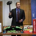 James Swartz, director of World Against Toys Causing Harm Inc., holds up toy battle hammer at Children's Franciscan Hospital in Boston, Wednesday, Nov. 19, 2014. The consumer watchdog group has released its annual list of what it considers to be the 10 most unsafe toys as the holiday season approaches. (AP Photo/Charles Krupa)