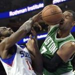 Celtics forward Jared Sullinger gets a face full of basketball courtesy of 76ers forward Luc Richard Mbah a Moute.
