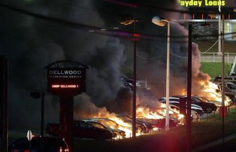 Fires burned in a used car lot in nearby Dellwood, Missouri.
