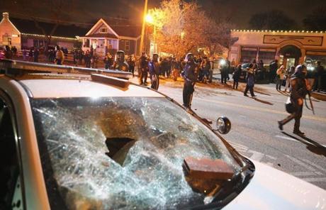 A damaged squad car can be seen as police confronted protesters in Ferguson.

