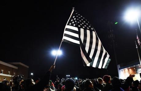 A demonstrator waved a modified black-and-white US flag during the protests.

