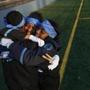 Santiago Martinez, Miasia Kemp, and Nia Richardson, hugged to stay warm during practice in Jamaica Plain Nov. 19. 