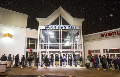 Hundreds of people waited outside Watertown Mall early Friday.
