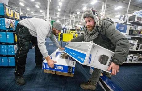 Tim Graham (left) and Frank Ford, of Watertown, loaded items into their cart.
