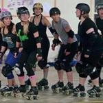 Derby Dames skaters listen to a coach during practice in Somerville.