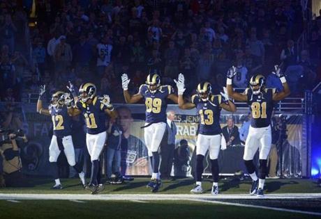 Several Rams players raised their hands to show support for Michael Brown, an unarmed black teen who was fatally shot by a white police officer in a St. Louis suburb in August.
