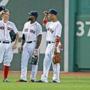 07/01/14: Boston, MA: Brock Holt, left, Jackie Bradley, Jr., center, and Mookie Betts, right, became the first three rookies to start a game together in the outfield (before September 1st callups) since Todd Benzinger, Ellis Burks and Mike Greenwell did it in 1987. They are shown during as pitching change chatting in center field. The Boston Red Sox hosted the Chicago Cubs in an inter league MLB game at Fenway Park. (Jim Davis/Globe Staff) section: sports topic: Red Sox-Cubs (1)