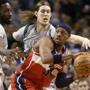 Washington Wizards forward Paul Pierce, right, looks for an opening around Boston Celtics forward Jeff Green, left, and center Kelly Olynyk, behind, in the second quarter of an NBA basketball game, Sunday, Dec. 7, 2014, in Boston. (AP Photo/Steven Senne)