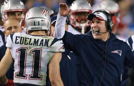 Julian Edelman is happily greeted by offensive coordinator Josh McDaniels after his fourth-quarter touchdown.
