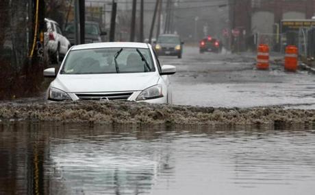 A car struggled through the water on Vale Street in Everett.
