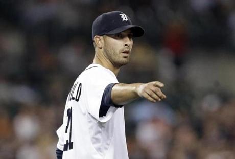 Detroit Tigers pitcher Rick Porcello points to Miguel Cabrera after making a play against the New York Yankees in the eighth inning of a baseball game in Detroit Tuesday, Aug. 26, 2014. (AP Photo/Paul Sancya)
