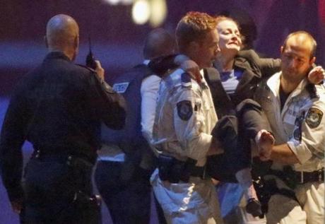 Police carried an injured woman from the Lindt cafe after the siege ended.
