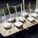 For a catered party in Cohasset, Kate?s Table prepared marshmallows dipped in chocolate on a bed of graham cracker crumbs.