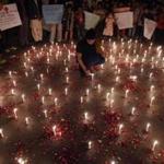 A Pakistani girl lit candles in Karachi for the victims of the school attack.