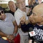 Angel Perez, who supports President Obama, listened to former prisoner Rafael Dominguez disagree with the president?s  action in Miami on Thursday.