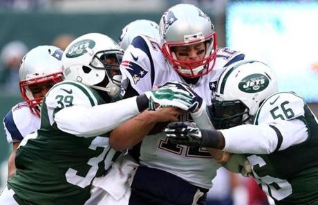 Tom Brady was sacked by the Jets' defense in the first half.
