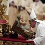 Pope Francis kissed a baby Jesus statue as he lead the midnight Christmas Mass in Saint Peters Basilica at the Vatican. 