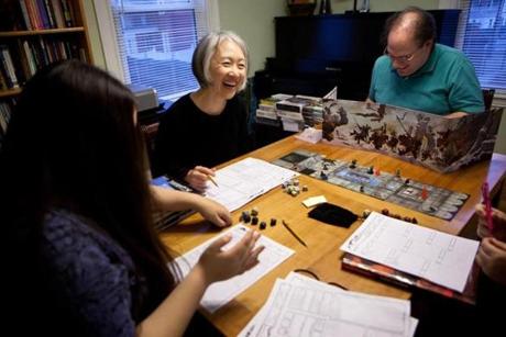 From left: Sophia, Jung, and Charles Starrett play D&D at home.

