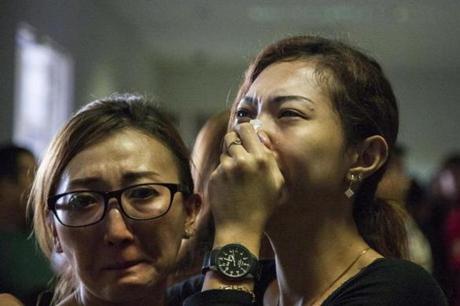 Relatives of passengers awaited news of the missing AirAsia plane Sunday at Juanda Airport in Surabaya, Indonesia.
