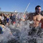 Hundreds of people plunged into the Boston Harbor on Thursday.