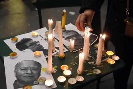 Candles were placed near the portraits of three of the four cartoonists killed in the attack in Paris.
