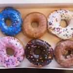 A box of donuts, (from top L clockwise) manager's special, traditional glazed, vanilla, pumpkin, chocolate and strawberry, is pictured at a newly opened Dunkin' Donuts store in Santa Monica, California September 2, 2014. The store is the first one from the chain to open in the Southern California area. REUTERS/Mario Anzuoni (UNITED STATES - Tags: FOOD BUSINESS)