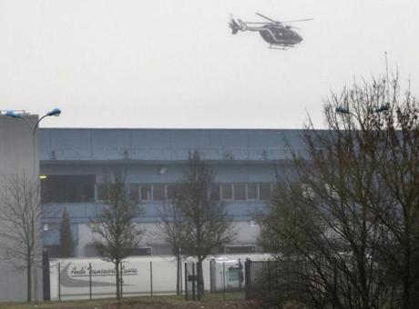 A helicopter flew over Dammartin-en-Goele, France, early Friday, where law enforcement personnel were hunting for the two brothers accused in Wednesday?s massacre in Paris.
