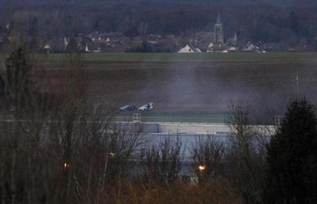 Smoke rose from a building northeast of Paris where two brothers suspected in the Charlie Hebdo attack were cornered.
