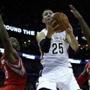 New Orleans Pelicans guard Austin Rivers (25) lays in a reverse layup around Houston Rockets forward Joey Dorsey (8) and forward Josh Smith (5) in the second half Jan. 2 in New Orleans. (Buth Dill/Associated Press)