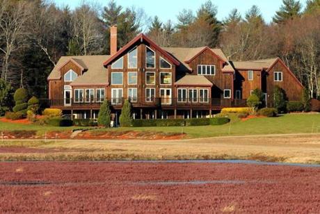 The great room of this post-and-beam home overlooks 17 acres of cranberry bog. 
