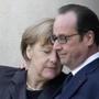 French President Francois Hollande embraced German Chancellor Angela Merkel as she arrives at the Elysee Palace in Paris Sunday.