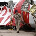 An Airbus investigator walks near part of the tail of the AirAsia QZ8501 passenger plane in Kumai Port, near Pangkalan Bun, Central Kalimantan January 12, 2015. Flight QZ8501 vanished from radar screens over the northern Java Sea on December 28, 2014 less than half-way into a two-hour flight from Indonesia's second-biggest city of Surabaya to Singapore. REUTERS/ (INDONESIA - Tags: DISASTER TRANSPORT TPX IMAGES OF THE DAY)