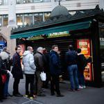 People waited in line to get a copy of satirical French magazine Charlie Hebdo in front of a kiosk in Paris.