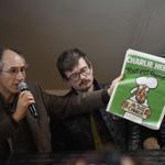 Editor in chief of French satirical weekly Charlie Hebdo Gerard Briard held up the newest issue.