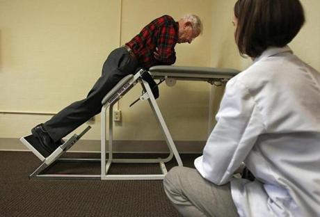 At Spaulding Hospital in Cambridge, Laura Ann Kurlinski assessed Richard Davenport, 90, for strength and flexibility.  Researchers are seeking ways to improve mobility in senior citizens.
