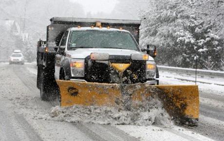 A plow cleared snow from School Street near the entrance ramps to Route 128 in Manchester-by-the-Sea Saturday. 
