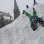 Amy Grace, 10, played on a snow mountain on Tremont Street in the South End Tuesday. A lot of people found the much-hyped storm easy to handle and got out to enjoy it.