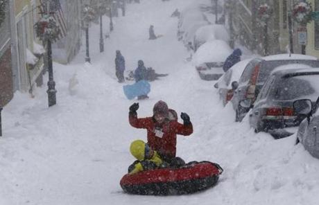 Children sledded down Pleasant Street in Charlestown during the blizzard. 
