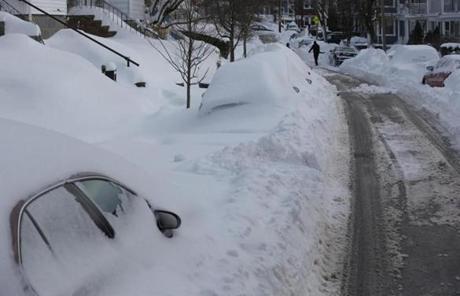 Cars were buried under snow on Chelmsford Street in the city.
