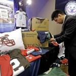 Homeland Security agent Gabriel Gonzalez displayed counterfeit goods at a news conference for the NFL Super Bowl XLIX game.