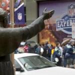 A statue of Pope John Paul II beckoned outside St. Mary?s Basilica, where NFL fans crowded the street.